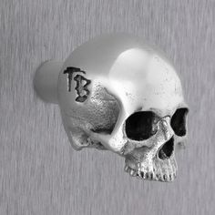 a silver skull ring with the word b on it