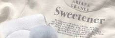 a white shirt with a blue and gray stuffed animal on it's chest that says sweetener