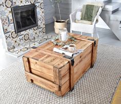 a living room with a coffee table made out of wooden pallets and a fire place