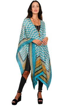 Our best seller know as our “Poncho” is a very easy to wear shape. It has open sides, a neckline in the center is the ESSENTIAL Travel Must have item! The poncho can be worn many ways such as shown; as a scarf, wrap around your hip as a sarong, one shoulder over a dress, and has many multi functions (see chart of many ways to wear). It’s the must have beach cover up and also looks great over jeans. We suggest you wear it on the plane to keep warm while traveling and this way you are sure you hav Beach Cape Shawl For Fall, One Size Shawl Cape For Beach, Beach Poncho With Batwing Sleeve For Fall, Batwing Sleeve Poncho For Beach In Fall, Blue Bohemian Cape Shawl, Oversized Cape Shawl For Spring, One Size Shawl Cape For Summer, Oversized Spring Cape Shawl, Bohemian Cape Poncho For Vacation