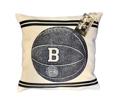 a black and white pillow with a basketball on it