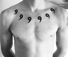 a shirtless man with an arabic tattoo on his chest