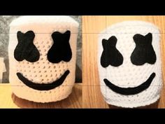 two crocheted mugs with faces on them, one is white and the other is black