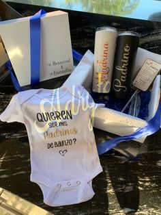 a baby's first birthday gift set with personalized onesuit and other items