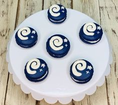 four blue and white cupcakes on a plate