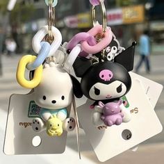 two key chains are attached to each other in the shape of an animal and cat