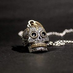 ¡Este es el colgante de calavera más malo que encontrarás en cualquier lugar! Inspirado en las calaveras ornamentadas del Día de los Muertos en México, el cautivador detalle presenta calaveras en miniatura en cada cuenca ocular y tallas intrincadas, y un medallón de la Virgen de Guadalupe.

 La profundidad incomparable de cada pieza, creada por el contraste del latón de joyero sobre la plata brillante, hace que sea imposible no sorprenderse. Con el verdadero pináculo de la orfebrería, cada pieza se elabora a mano en pequeños lotes con una increíble atención a la calidad.

 Como parte de nuestra colección exclusiva Las Calaveras, ¡combínalo con nuestro anillo Calavera Sugar Skull para completar el look!

 Llega listo para usar, nada más sacarlo de la caja.

 Material: Plata de Ley con lató Gothic Gold Engraved Jewelry, Symbolic Engraved Brass Jewelry, Collectible Silver Skull Necklace, Collectible Silver Skull Jewelry, Gold Skull-shaped Engraved Jewelry, Bohemian Sterling Silver Skull Jewelry, Bohemian Hand Cast Sterling Silver Necklace, Gothic Engraved Bronze Jewelry, Gold Skull Bohemian Jewelry