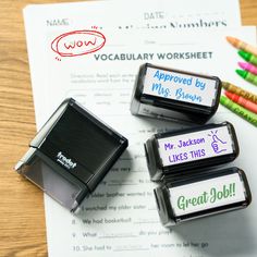 three personalized erasers sitting on top of a piece of paper next to colored crayons