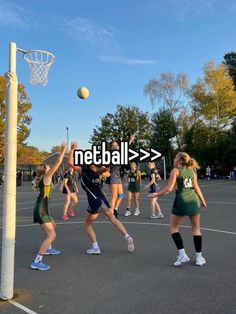 several girls are playing basketball on an outdoor court