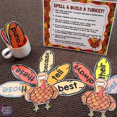 two turkeys are on the floor next to a coffee cup and sign that says spell & build a turkey