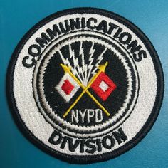 a patch with the words communcations nypd division on it