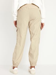 elastic-drawstring waist faux fly front pockets flap-cargo pockets at thigh side-zip hem elasticized cuffs sits at belly button loose hip and thigh tapered leg hits at ankle 29" regular inseam 27" petite inseam 32" tall inseam models are approx.  5'9" and wear sizes s (4), l (12), and xl (18)machine wash according to the care instruction label