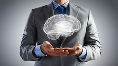 a man in a suit holds out his hand with a glowing brain inside the center