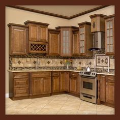 a large kitchen with wooden cabinets and tile flooring, including a stove top oven