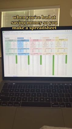 an open laptop computer sitting on top of a table with a spreadsheet in front of it