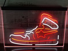 a neon sign with a shoe on it