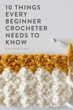 the crochet book is laying on top of it's white cover and yellow trim