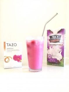 a pink drink next to a carton of tazo