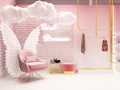 a pink room with angel wings on the wall and a chair in front of it