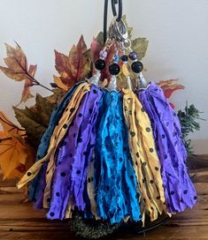 the purse is made out of fabric and has beads on it's sides, along with leaves