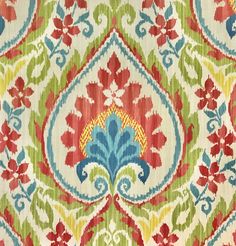 an ornate pattern on fabric with red, green and blue colors