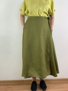 "Handmade olive color linen long wrap skirt with pockets, perfect for casual wear and suitable for any occasion in any season Details: - 100% natural linen produced in Europe ; - medium weight (180 gram per square meter); - color: could be any from our colors catalog (color samples at the photo); Made to order, approximately a few days, If you have any questions please message me and I will be glad to answer. Size guide : Size XS Bust: fits bust around 33\"-34\"/ 84-88 cm Waist: fits waist aroun Solid Long Linen Skirt, Solid Color Long Linen Skirt, Summer Linen Asymmetrical Maxi Skirt, Summer Linen Asymmetrical Wrap Skirt, Summer Asymmetrical Linen Wrap Skirt, Spring Wrap Skirt, Green Maxi Skirt With Pockets For Summer, Relaxed Green Cotton Wrap Skirt, Green Relaxed Cotton Wrap Skirt