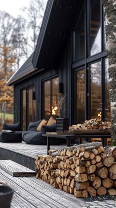 a stack of logs sitting on top of a wooden deck