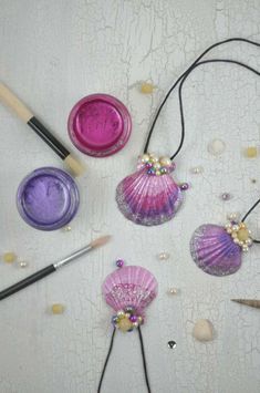 some crafting supplies are laid out on a table with beads and other items around them