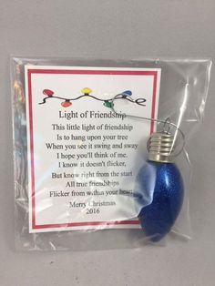 a blue ornament hanging from a string with a poem on it's side