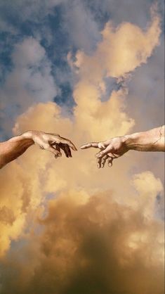 two hands reaching out towards each other in front of a cloudy sky with white clouds