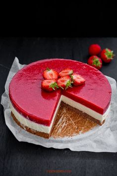 a strawberry cheesecake with one slice cut out