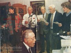 a group of men standing next to each other in front of microphones and papers