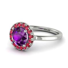 a purple ring with red stones on it