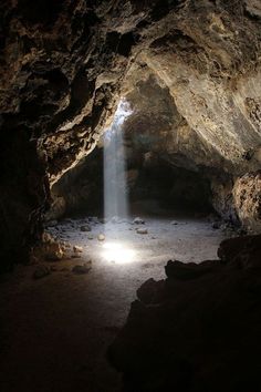 the light shines through an opening in a cave