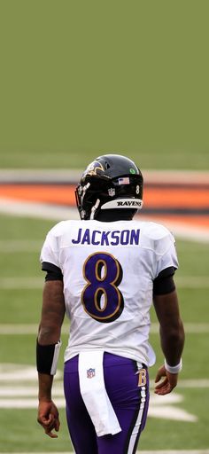 a black and white photo of a football player with the number 8 on his uniform