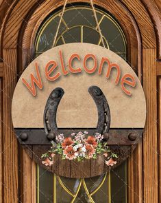 a welcome sign hanging from the side of a wooden door with flowers on it's handle