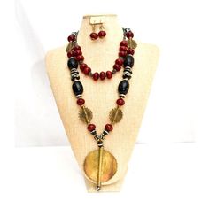 Beautiful black and maroon amber necklace with brass. Comes with matching earrings. Amber Wooden Beads For Jewelry Making, Amber Artisan Jewelry With Wooden Beads, Artisan Amber Jewelry With Wooden Beads, Traditional Brown Jewelry With Black Beads, Handmade Black Brass Necklace, Bohemian Amber Jewelry With Wooden Beads, Artisan Black Brass Necklaces, Unique Black Brass Jewelry, Black Brass Spiritual Jewelry