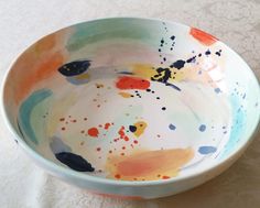 a colorful bowl sitting on top of a white table