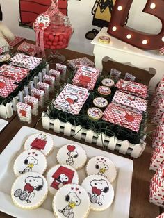 a table topped with lots of cookies and cupcakes