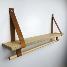 a wooden shelf mounted to the side of a wall