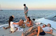 group of people sitting on the back of a boat