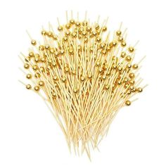 some gold colored pins on a white background