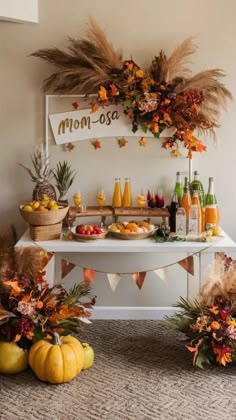 a table topped with lots of food next to two pumpkins and other decorations on top of it