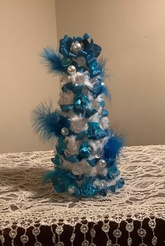 a blue and white christmas tree on a table