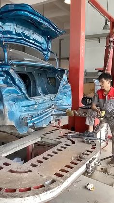 a man working on a car in a garage