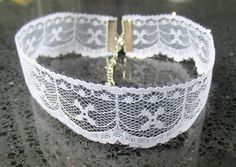 "\"Elegant Nostalgia: Vintage-Inspired White Lace Choker Necklace\" Indulge in timeless elegance with this exquisite vintage-inspired white lace choker necklace. The intricate lace design exudes a sense of delicate beauty, reminiscent of bygone eras. Each choker is meticulously crafted to capture the allure of vintage fashion, offering a touch of nostalgia to your ensemble. With a variety of designs available, you can choose the lace pattern that speaks to your personal style. Whether you prefer Classic White Choker For Party, White Classic Choker For Party, Delicate White Choker For Wedding, Elegant White Choker For Anniversary, Delicate White Lace For Party, Delicate White Wedding Choker, Elegant Adjustable Lace Choker, Delicate Adjustable Choker For Wedding, Vintage Lace Jewelry For Gifts