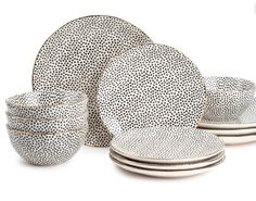 a white and black dinner set with dots on it