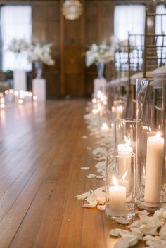 the aisle is lined with candles and petals