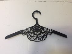 an umbrella shaped hanger on a white wall