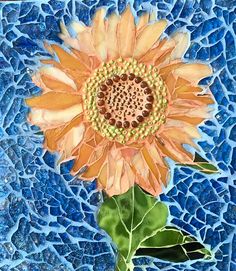 a painting of a sunflower on a blue mosaic tile background, with green leaves